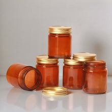 Scented candle in glass jar with airtight wooden lid and earthy label design.